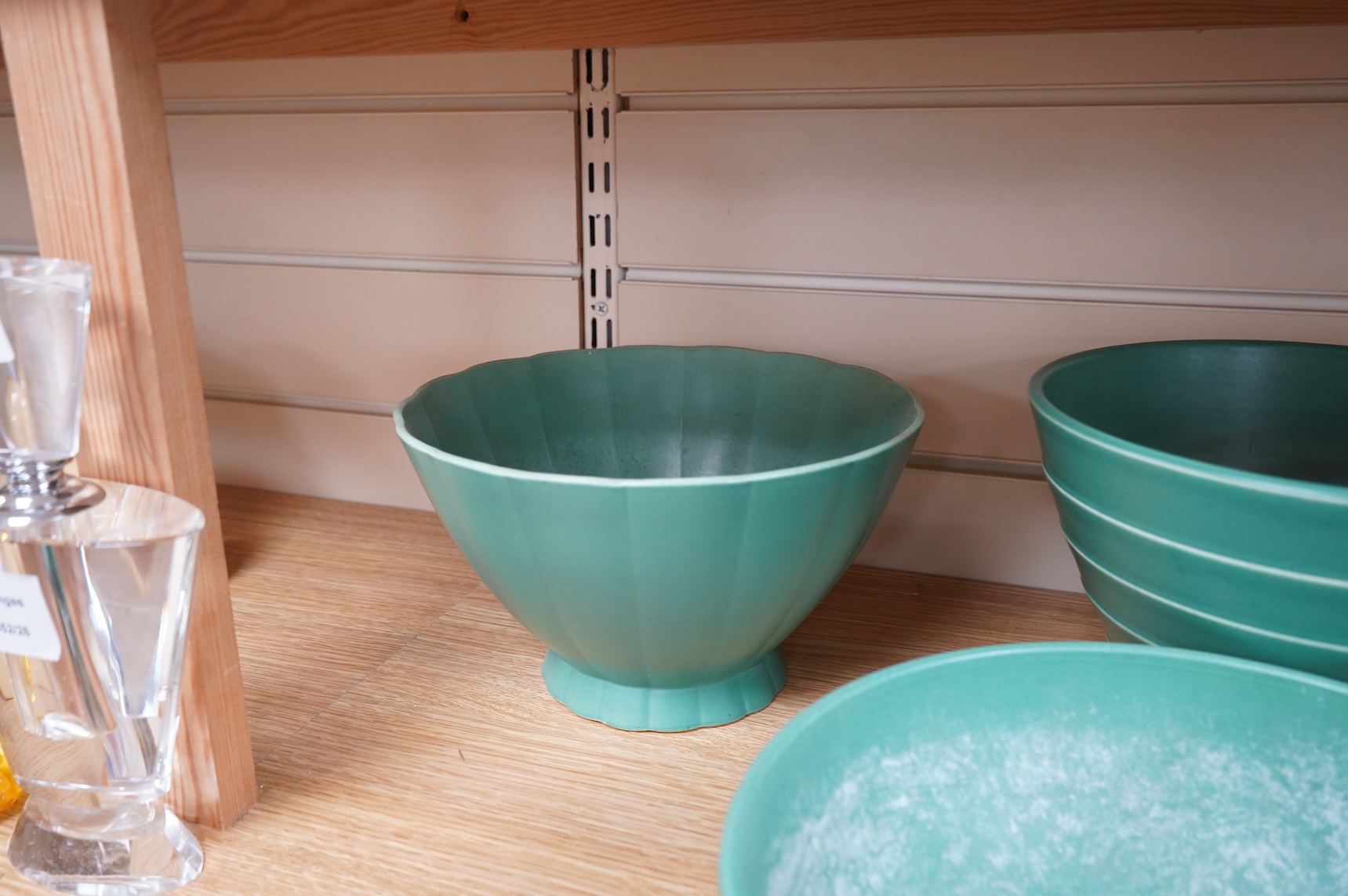 Keith Murray for Wedgwood, three green glazed bowls to include a ribbed example, largest 24cm in diameter